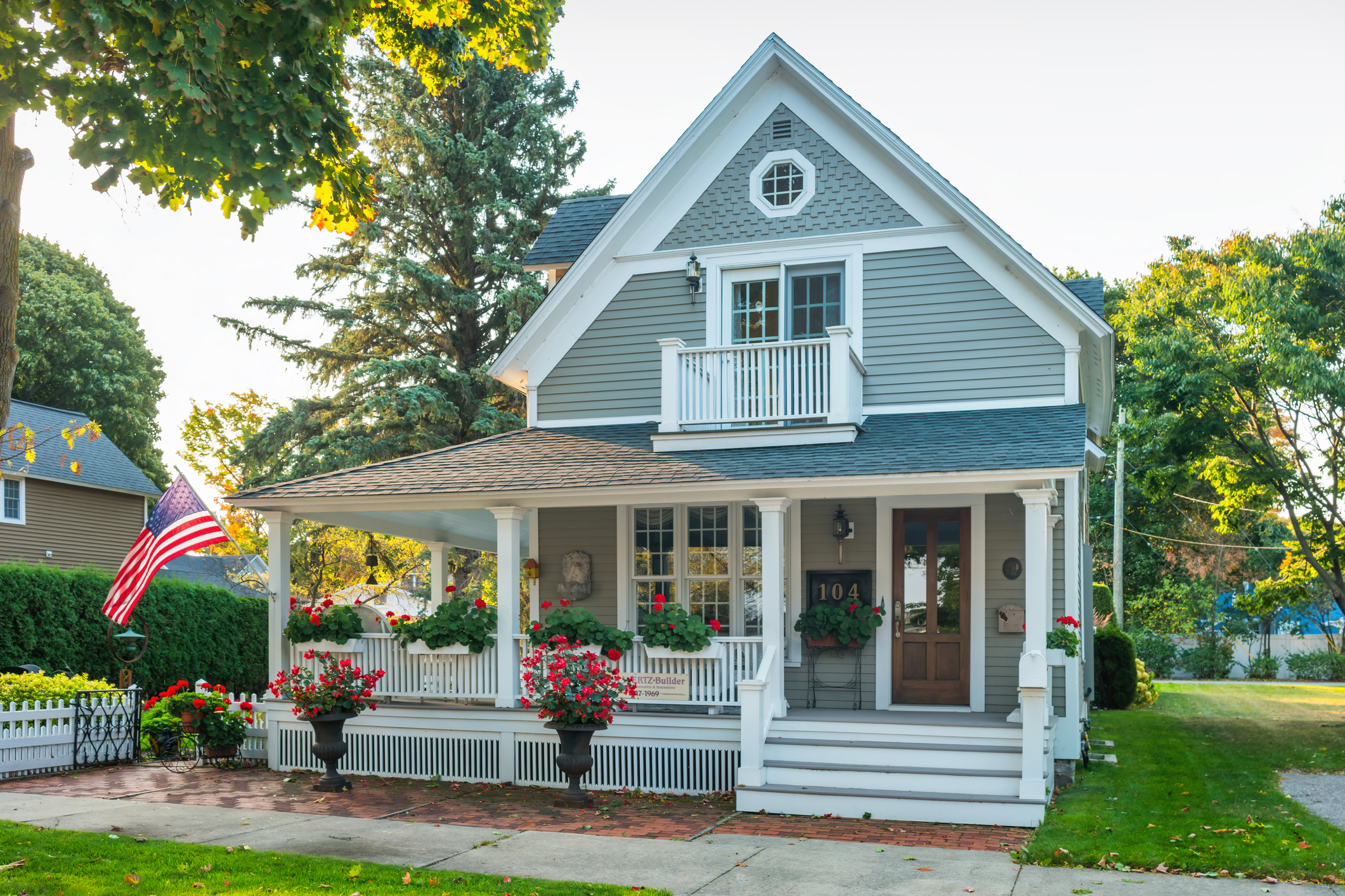 A welcoming suburban Colorado Springs home exterior in a neighborhood near Fort Carson, with mountains visible in the distance and an American flag on the porch. Alternatively, a warm interior shot that feels like home — family-ready, not showroom-stiff. Avoid anything that looks staged to the point of impersonal.