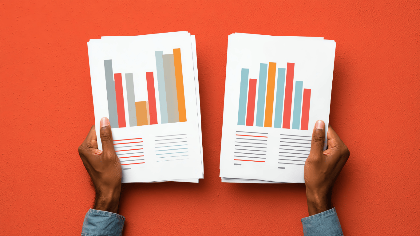 Hands holding printed business charts and analytics reports on an orange background, representing real estate market data and investment performance analysis.