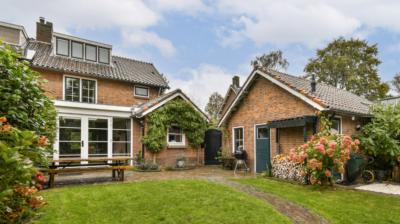 Charming brick backyard with cottage outbuilding.