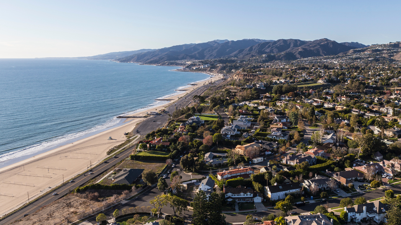 Aerial coastal neighborhood view with beach access.