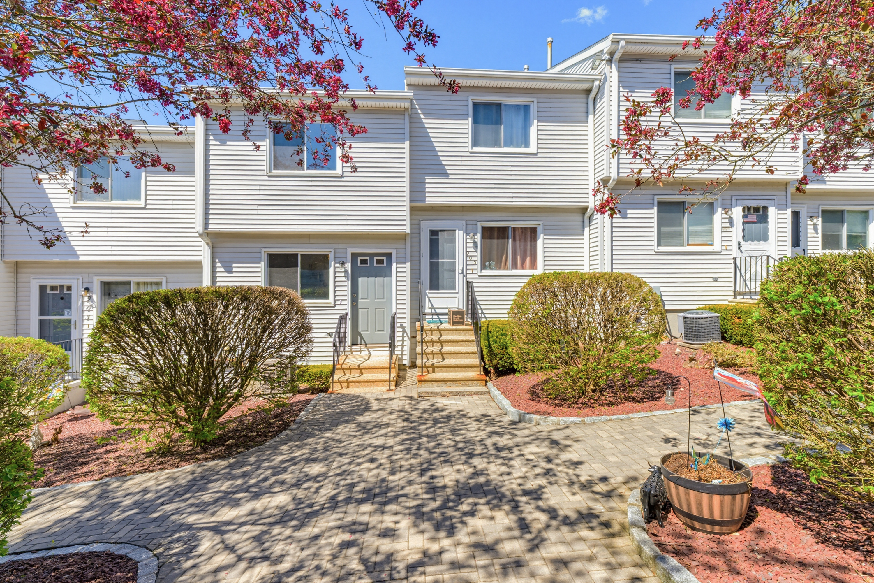 Turnkey two-bedroom Derby condo with refreshed kitchen, hardwood floors throughout, and attached one-car garage, offered at $289,000 and quickly in contract.
