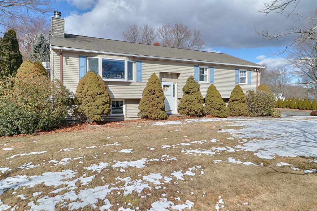 Ranch-style home with tan siding at 471 Edison Street, Trumbull CT, on a late winter day