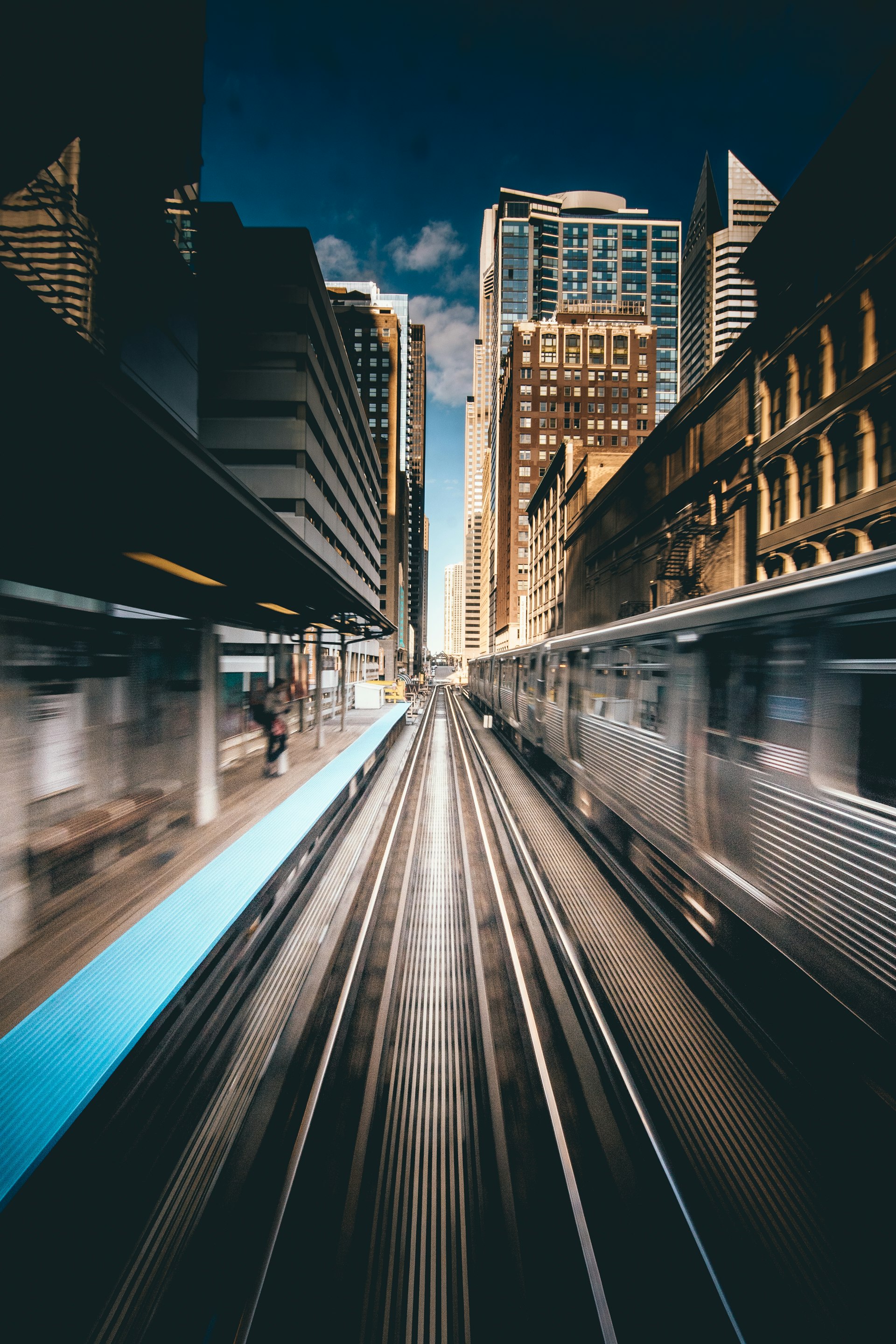 Elevated train pulling into a downtown station platform