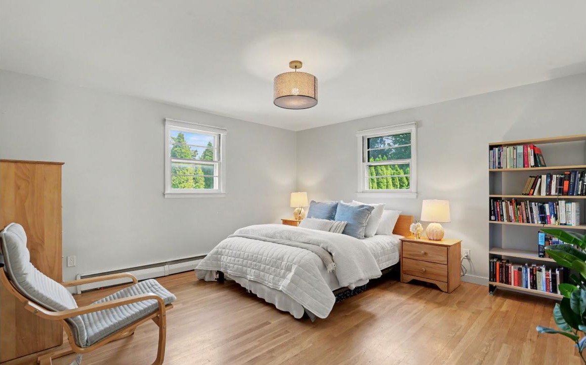 Oversized primary bedroom at 214 Alberta St, Fairfield CT with hardwood floors and two windows