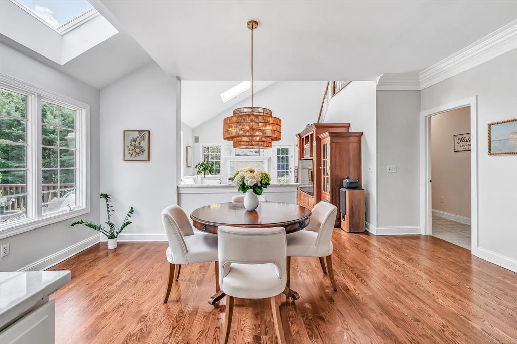 Dining room with vaulted ceiling, hardwood floors and a skylight at 159 Blue Bell Lane