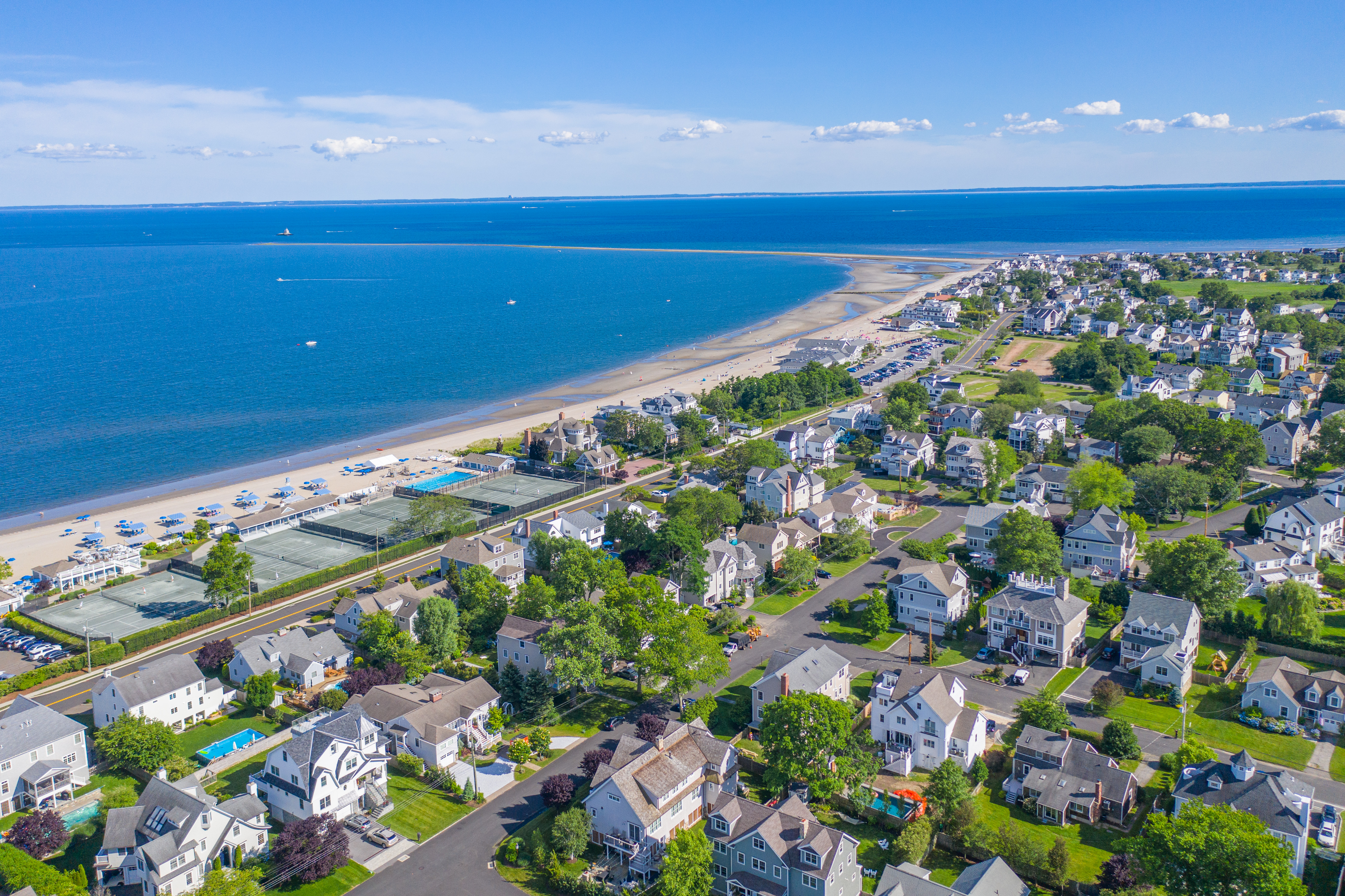 Aerial view of the Fairfield CT shoreline with the beach, Long Island Sound and coastal homes in summer