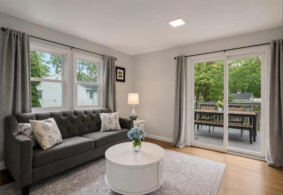 Sunlit den with sliding glass doors opening to the deck at 163 Windsor Rd, Fairfield CT