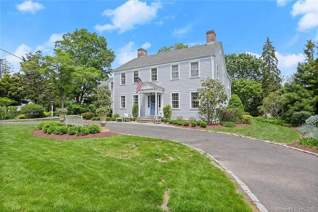 White Colonial with dark shutters, a curved driveway and mature landscaping at 419 Beach Road, Fairfield CT