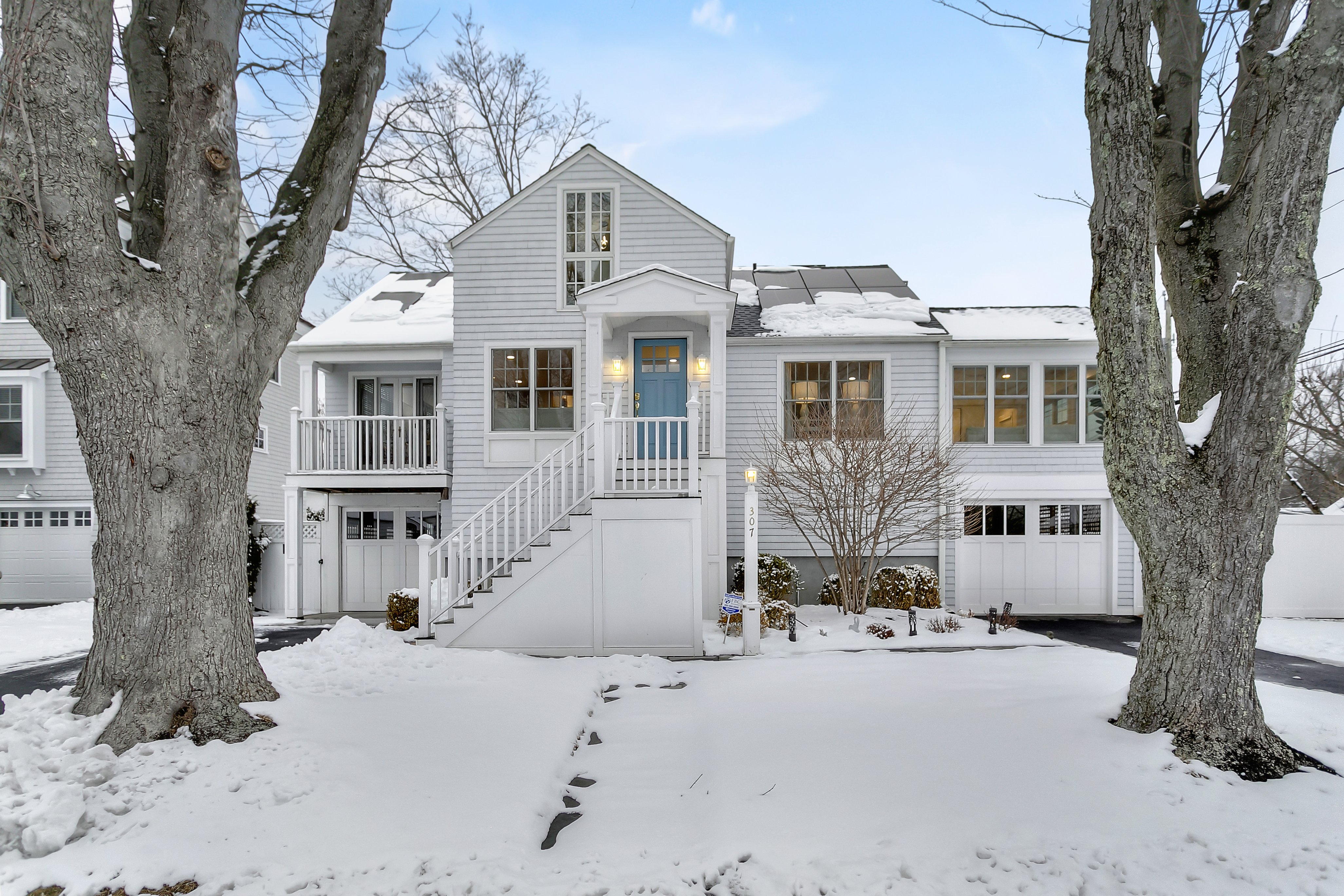 White shingled Cape Cod home at 307 Eastlawn Street, Fairfield CT, on a snowy winter day