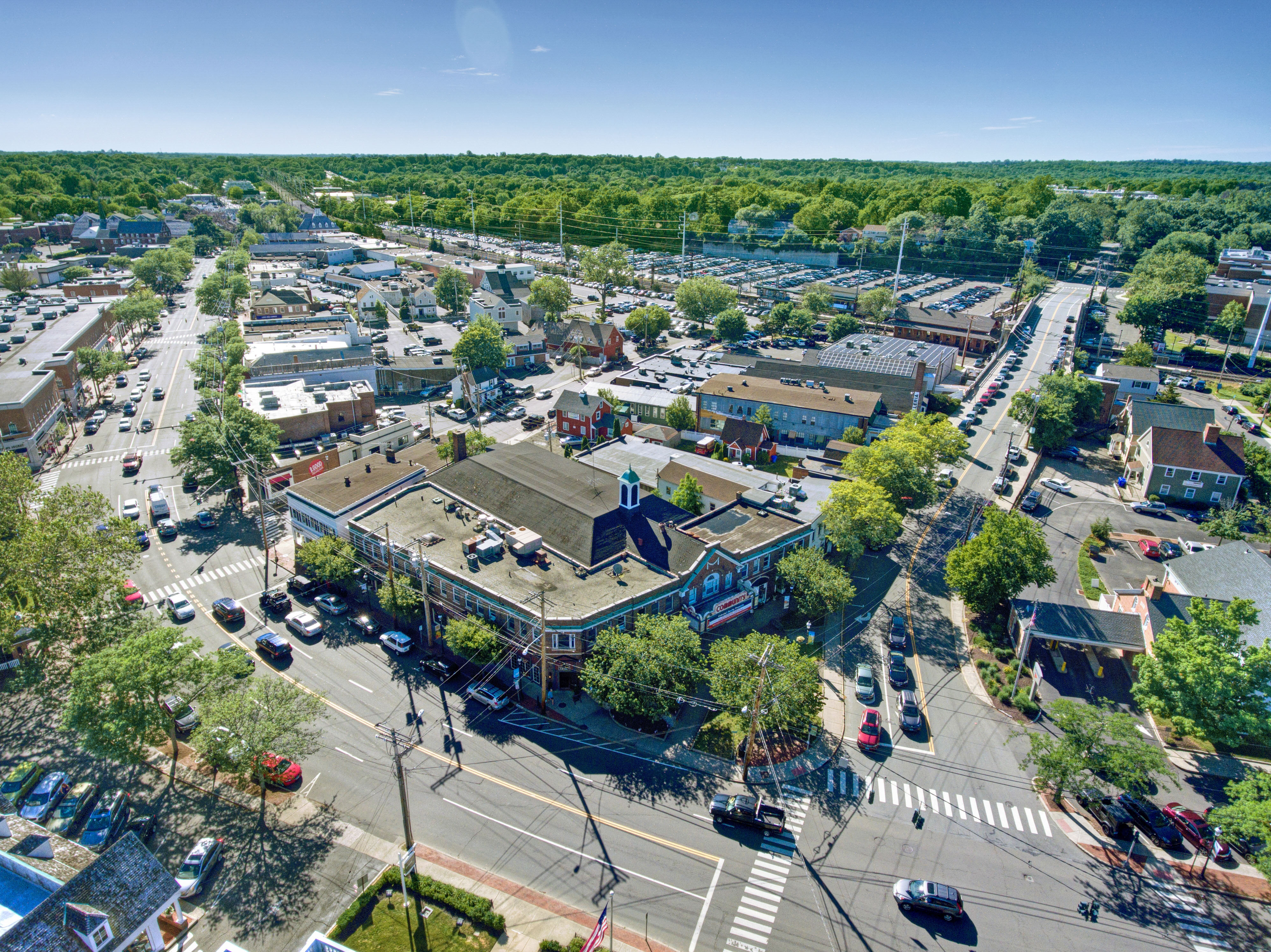 Aerial view of downtown Fairfield, CT, with Post Road shops, parked cars and tree-lined streets