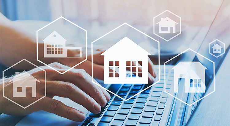 Hands typing on a laptop with illustrated house icons floating above the keyboard