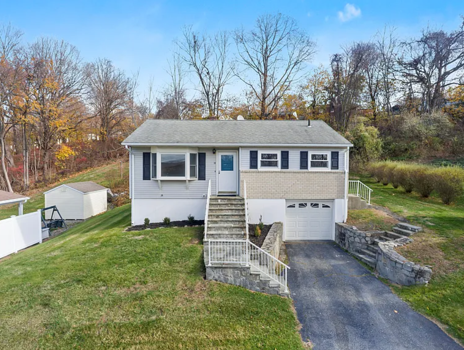 23 Berkshire Road, Ansonia CT — raised ranch with driveway and hillside behind