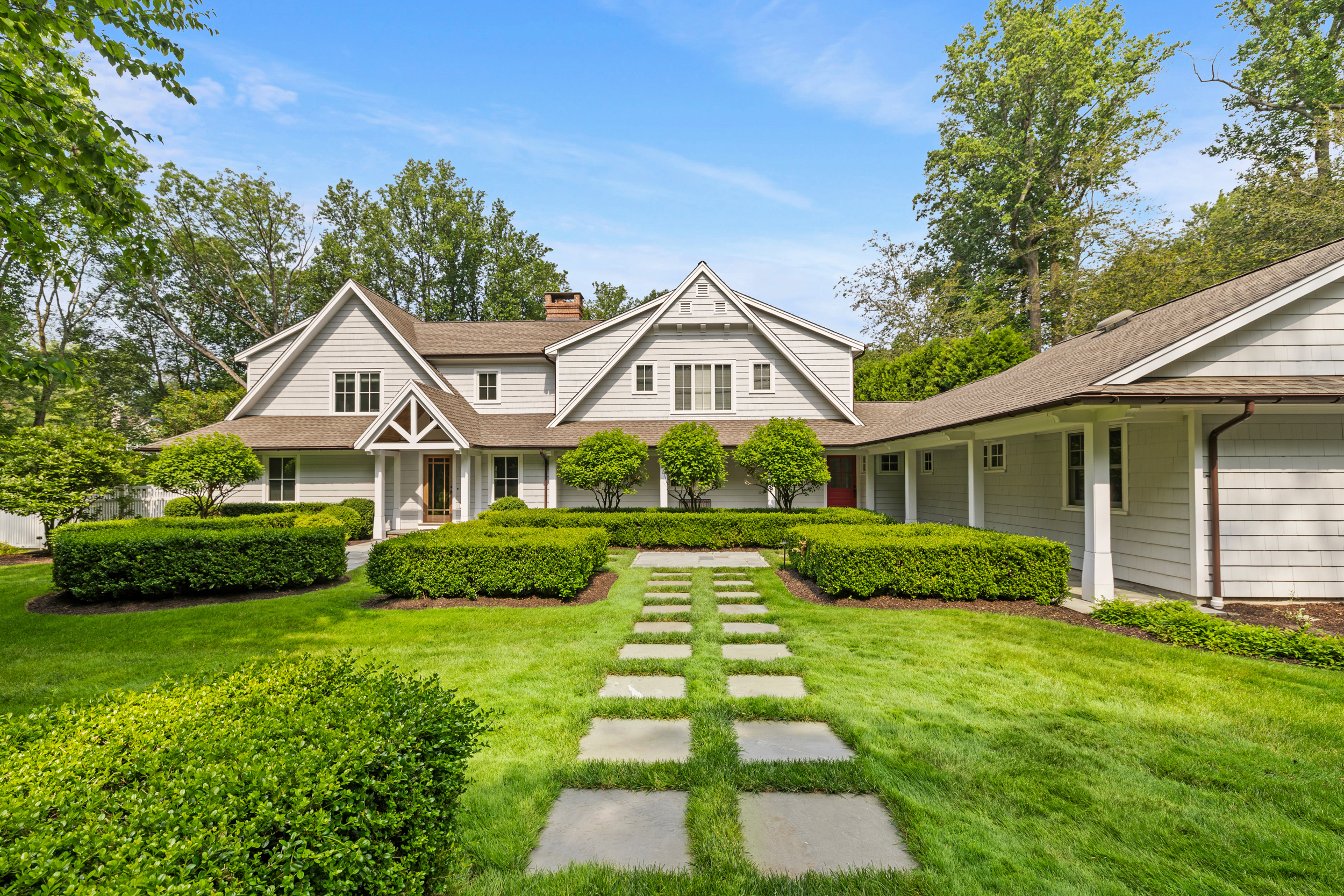 Shingled Westport home with dormers, clipped hedges and a stone paver walkway at 9 Woodside Lane, Old Hill