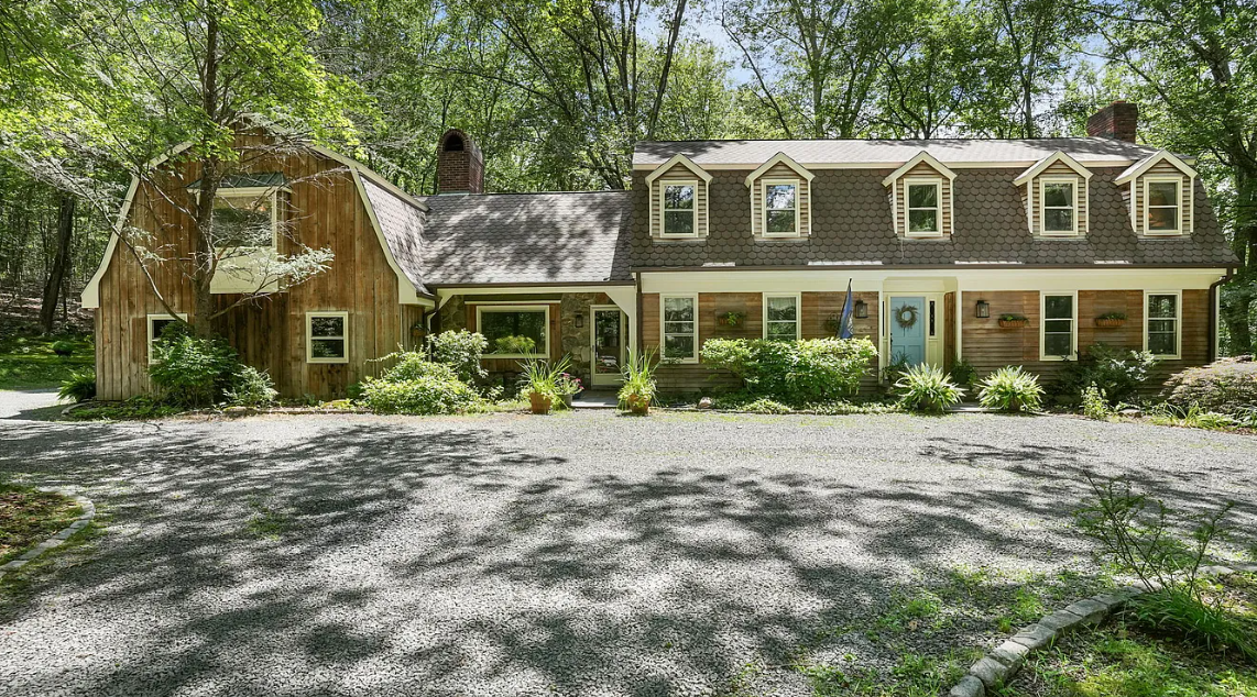 Shingled colonial with mature trees and gravel drive at 100 Honeysuckle Lane, Fairfield CT