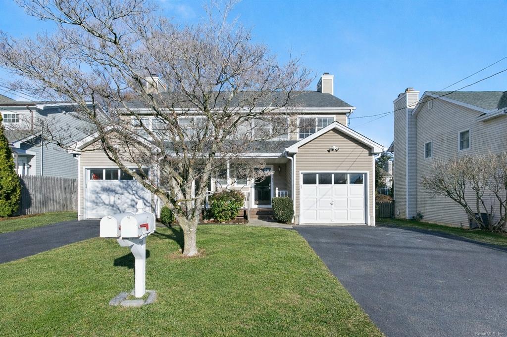 Two-unit property with attached garage and flowering tree at 30–32 Osborne Place, Fairfield CT