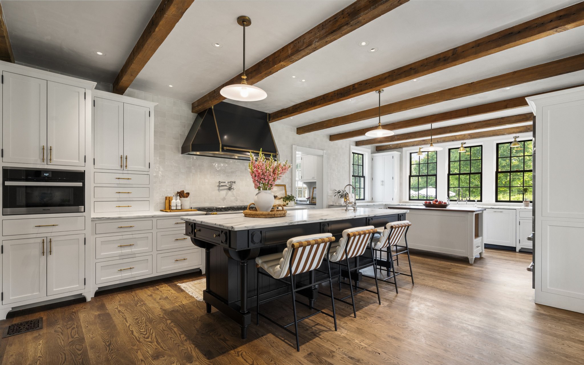 Custom chef kitchen with range hood, large island, and designer finishes at 98 Banks Place, Southport CT