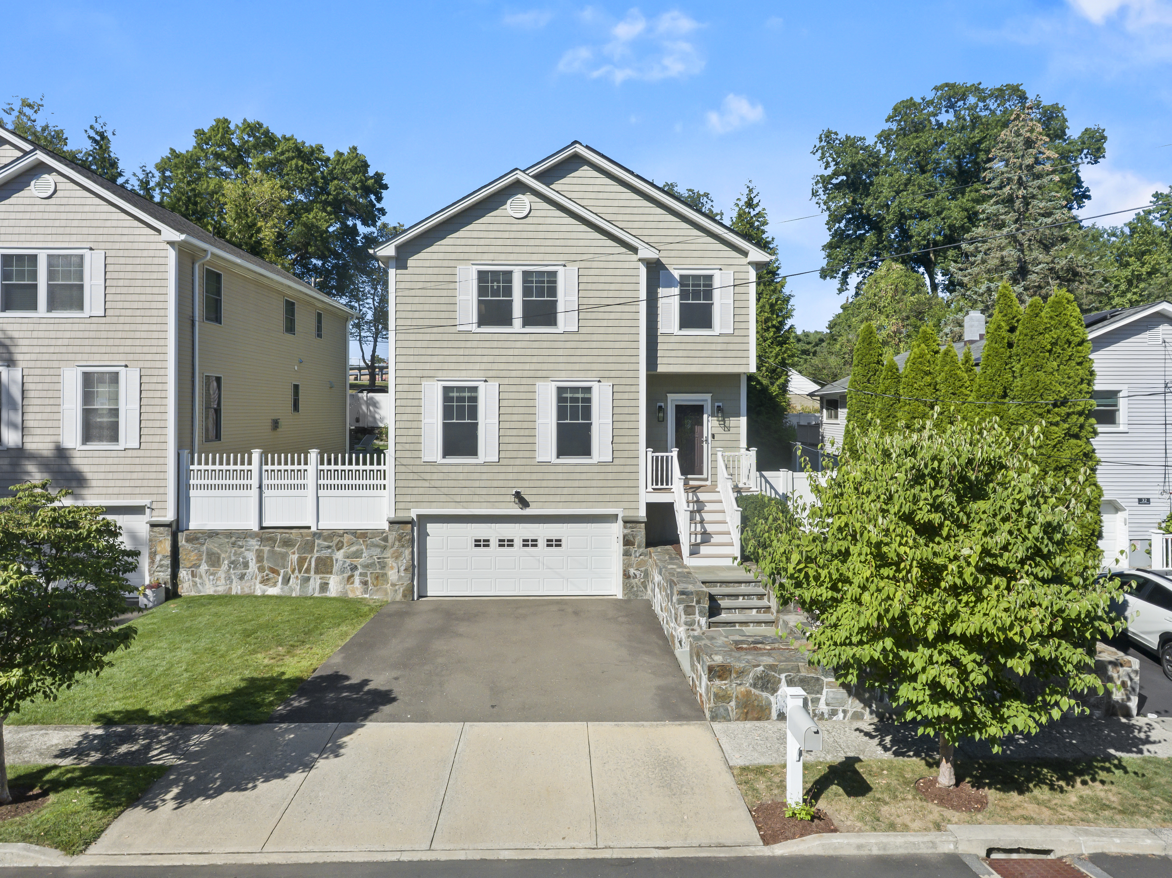 Gray Colonial with attached garage at the end of a quiet cul-de-sac in Fairfield, CT
