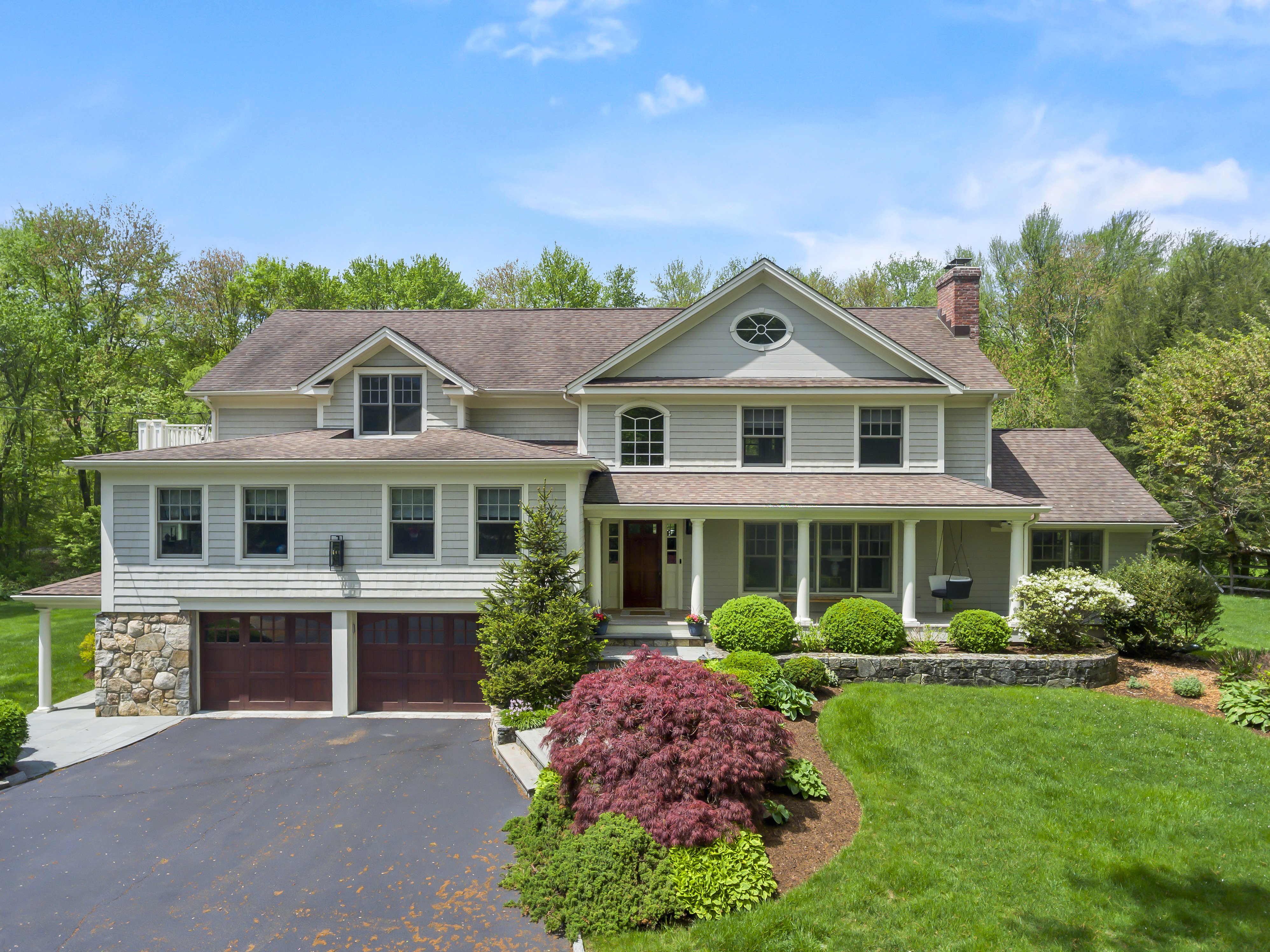 Vaulted family room with a wall of windows and built-in cabinetry at 180 Merwins Lane, Fairfield CT, now under contract