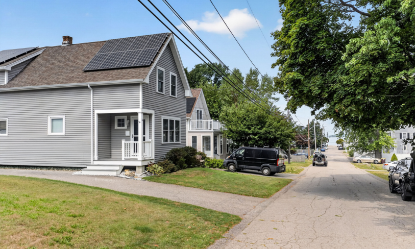 Weymouth Massachusetts home photographed with green lawn and mature trees ahead of a planned spring sale
