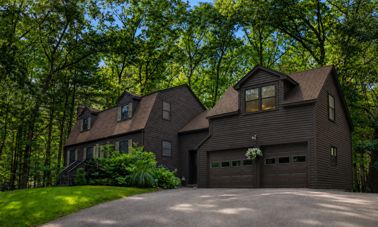 Conceptual example of a Greater Boston home with an accessory dwelling unit added above an attached two-car garage, illustrating one way a garage ADU can create additional living space.