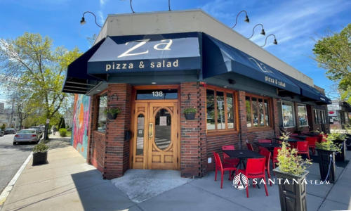 Exterior of Za Pizza & Salad in East Arlington, MA with outdoor seating and blue awning, photographed for the Santana Team blog about family-friendly restaurants.