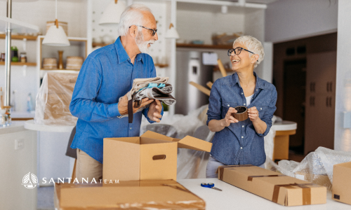 Smiling older couple packing boxes together in their kitchen while preparing to move in Greater Boston.