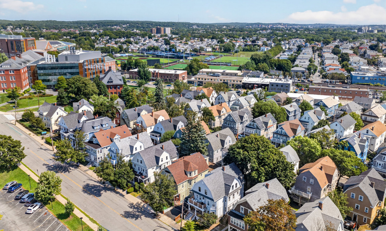 Aerial view of triple-decker homes and residential streets in Somerville, Massachusetts