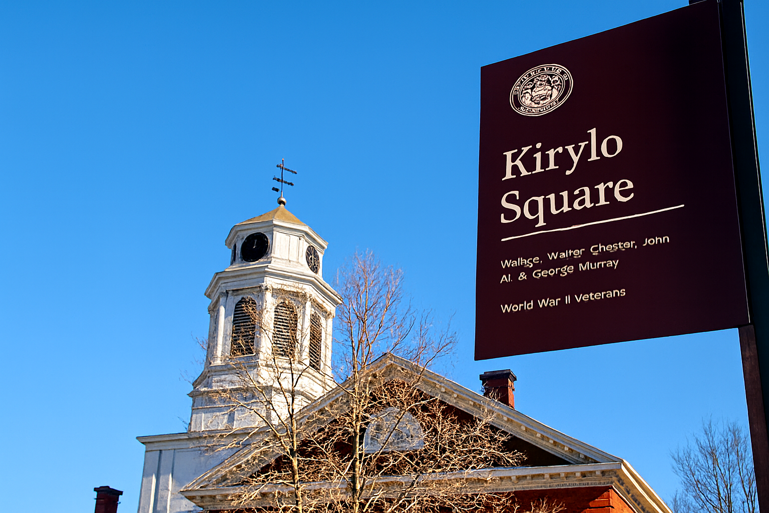 Kirylo Square sign in West Cambridge honoring World War II veterans, with a historic red brick building and white clock tower in the background against a clear blue sky.