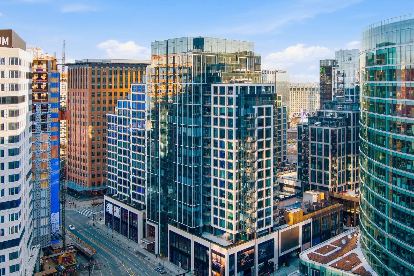 The EchelonSeaport towers on Seaport Boulevard, with ground-floor shops along the street in Boston's Seaport District