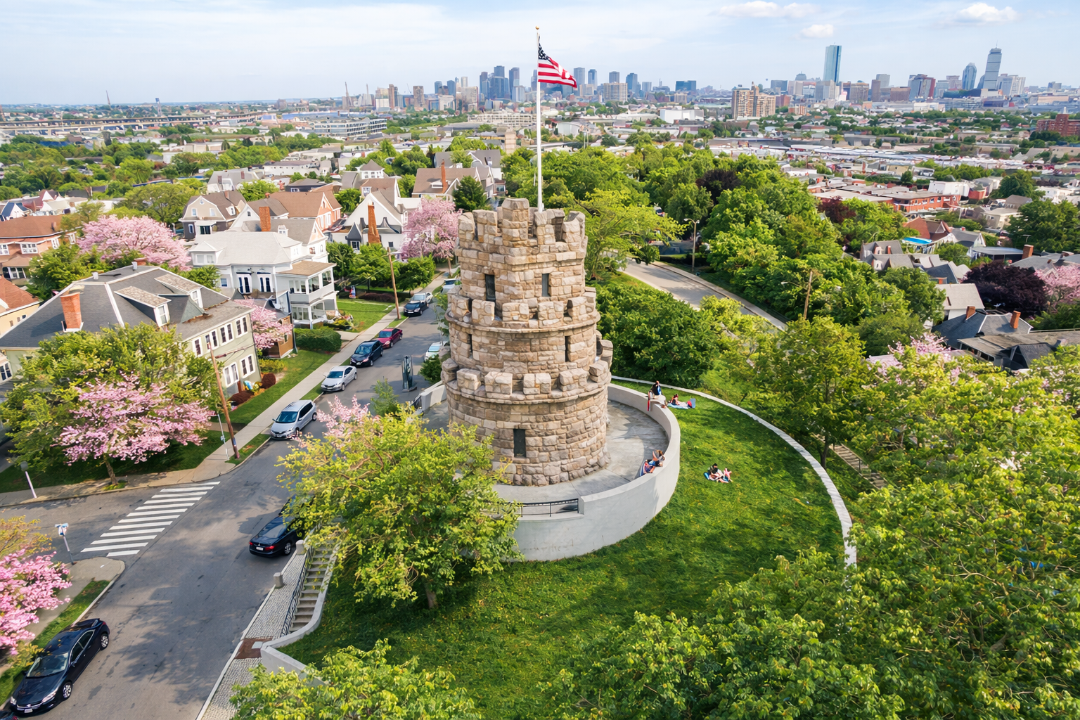 Spring aerial view of Prospect Hill Tower in Somerville MA with surrounding neighborhood and Boston skyline, representing the local real estate market in 2026