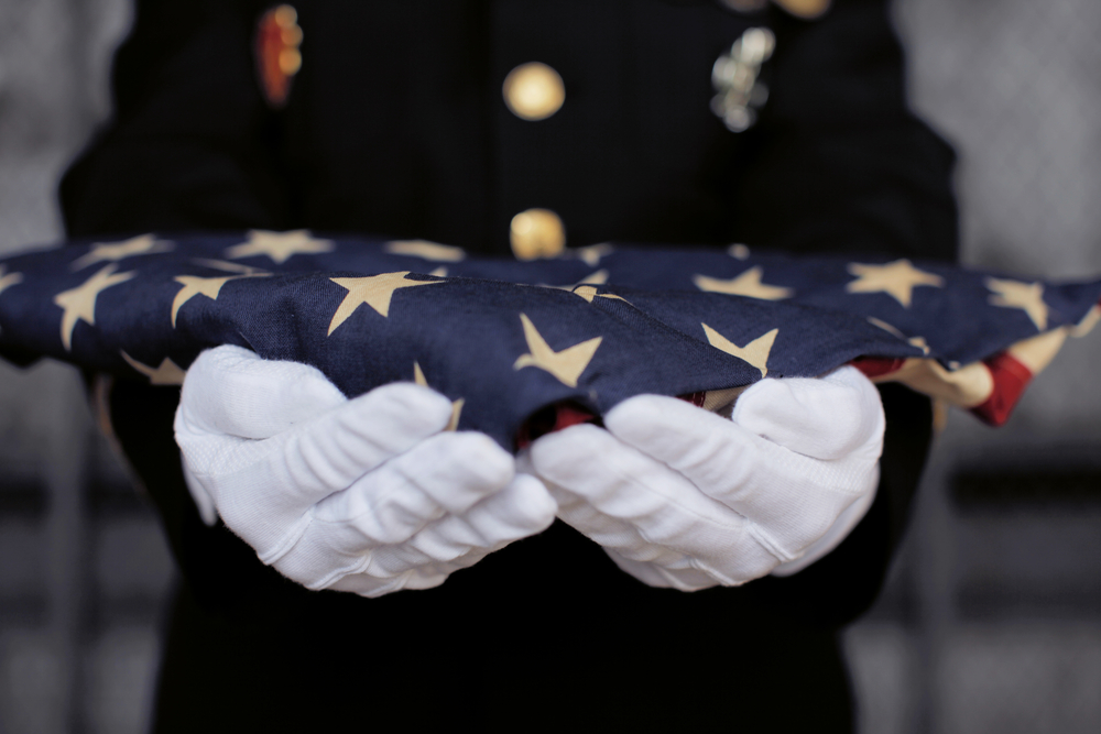Soldier presenting an American Flag