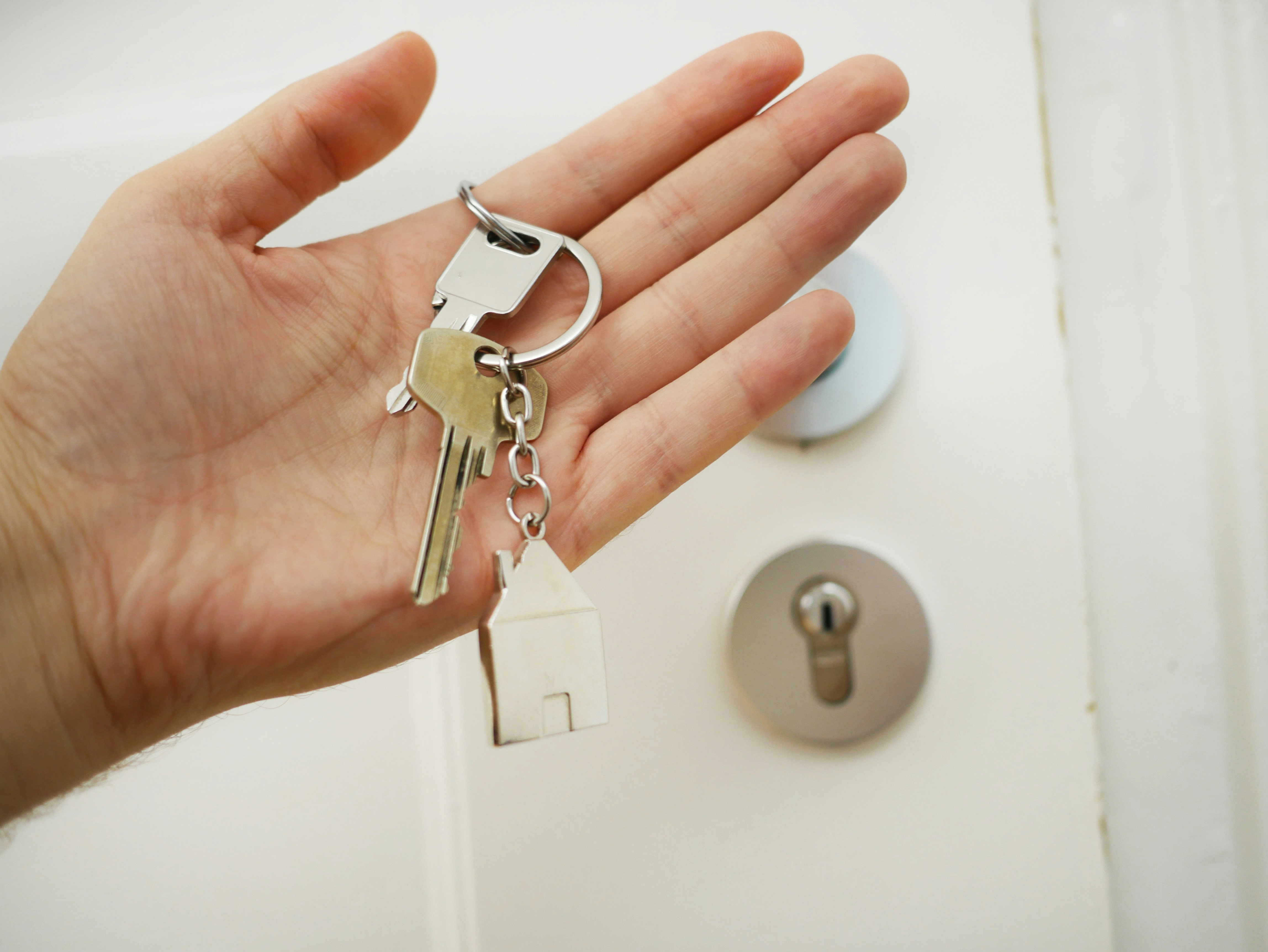 Hand holding homes keys