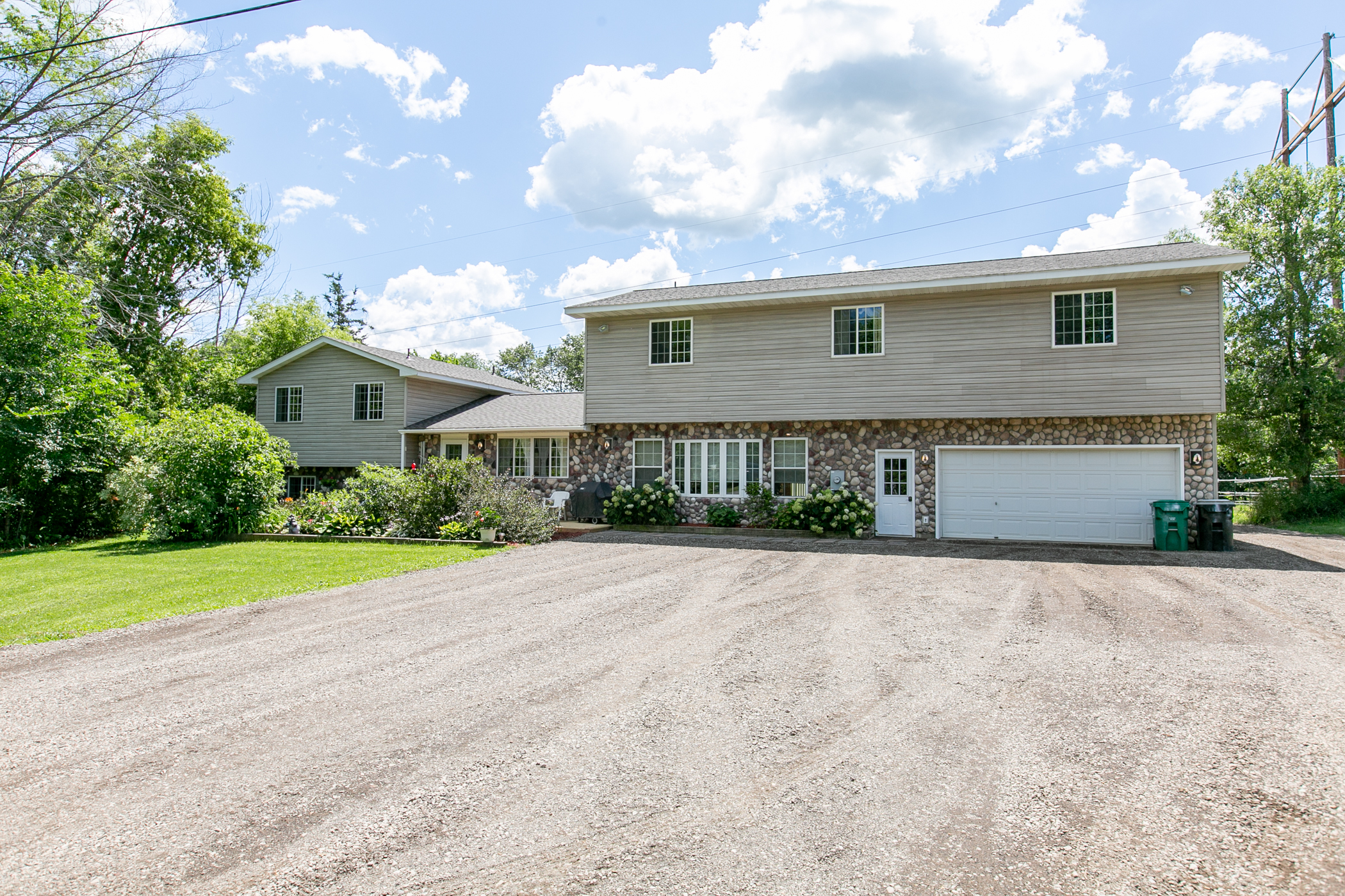Home for sale in Ramsey with a private backyard and a creek running through it! header image.