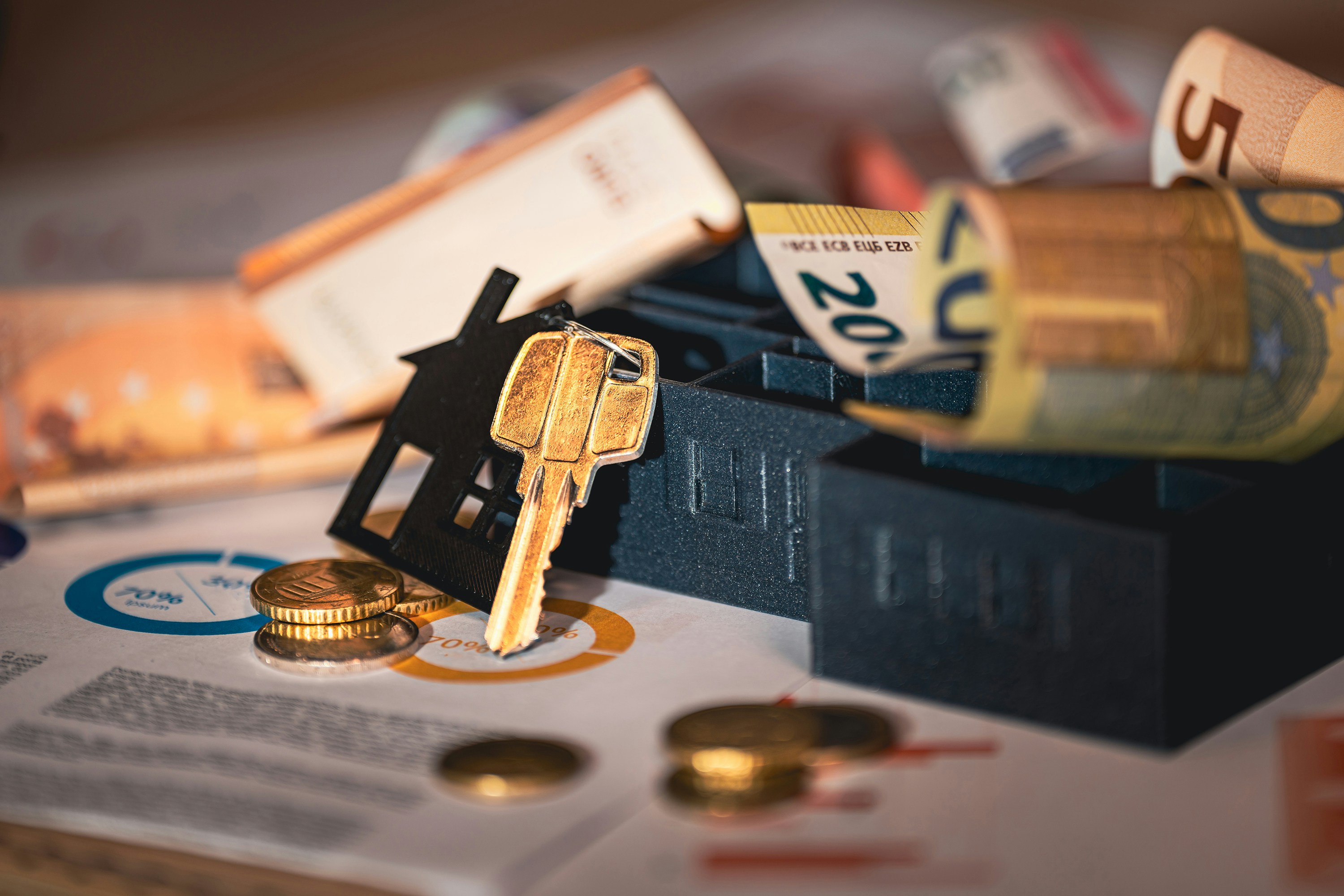 Close-up of house keys, calculator, and paperwork