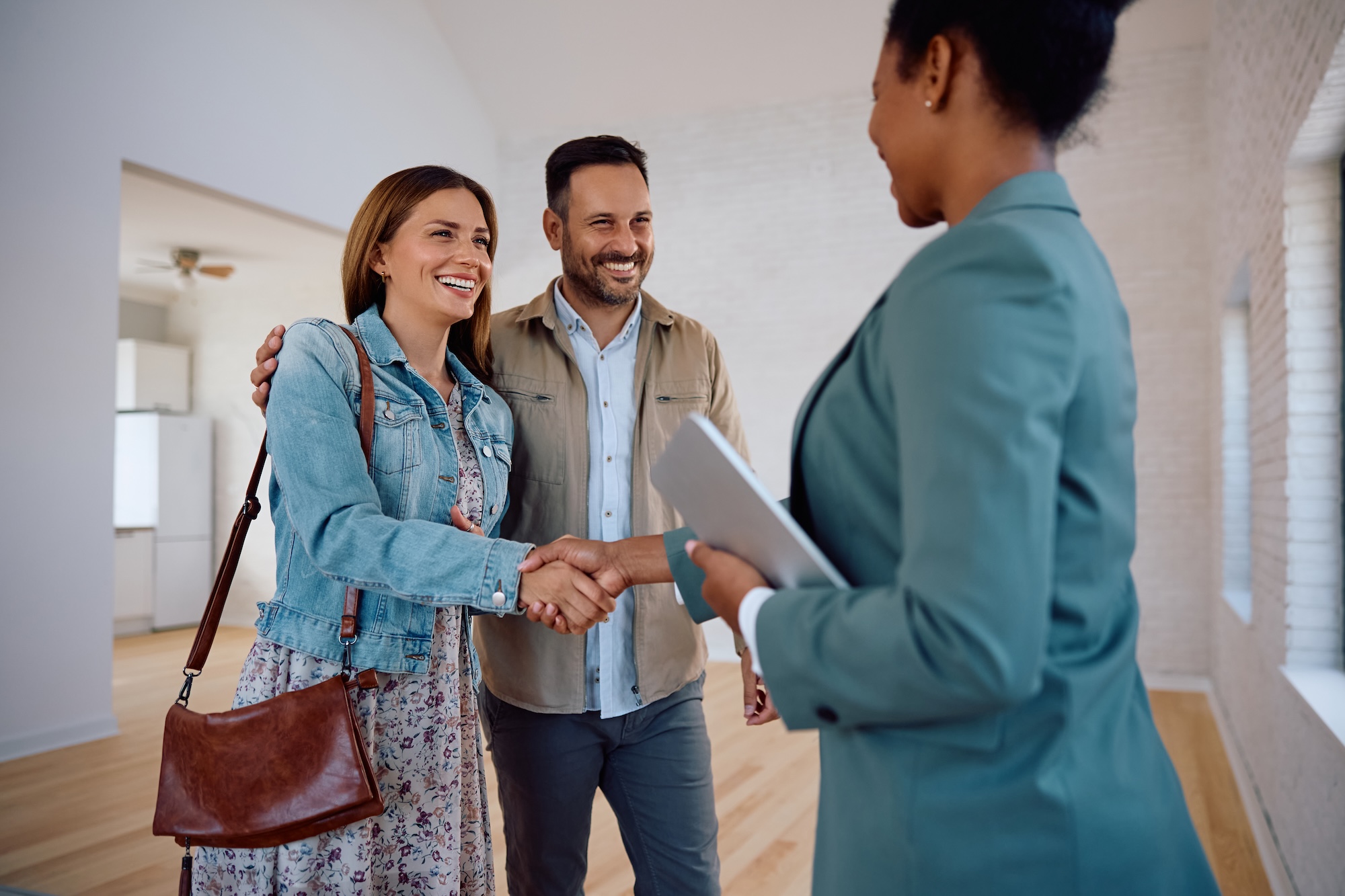 New homebuyers with their real estate agent.