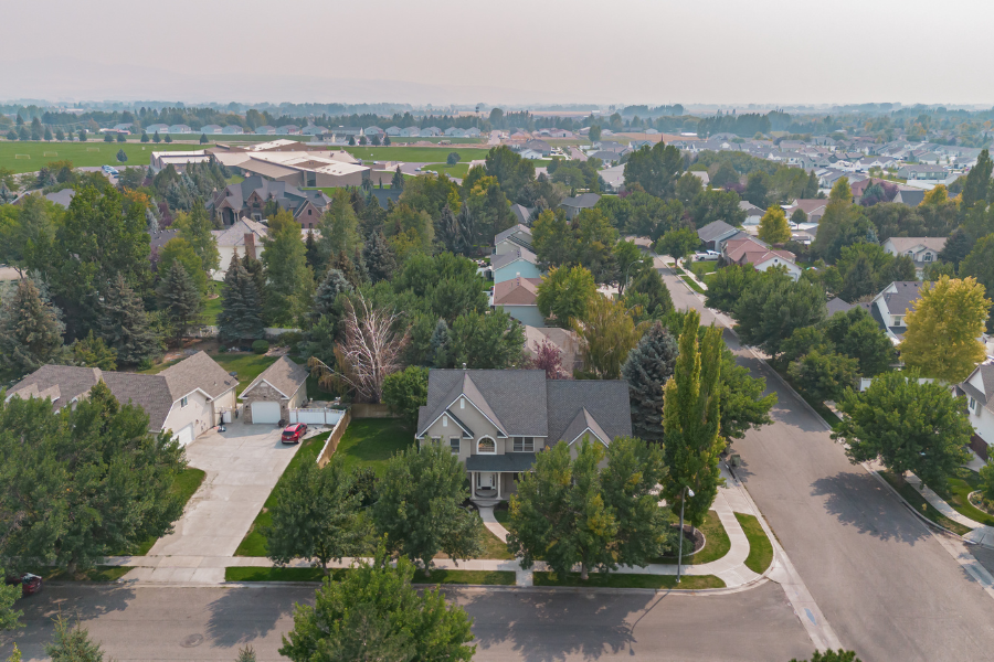 Aerial view of Idaho Falls neighborhood featuring single-family homes, tree-lined streets, and suburban layout
