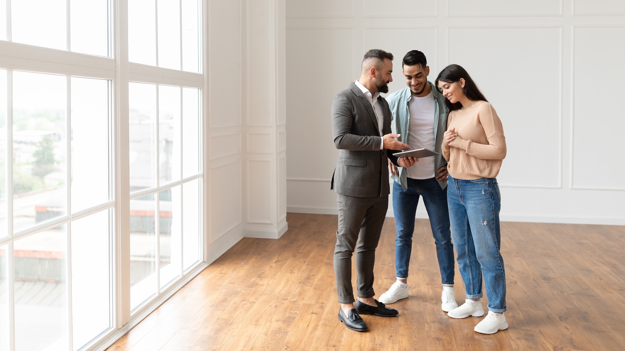 Couple looks at a new home with a real estate agent.