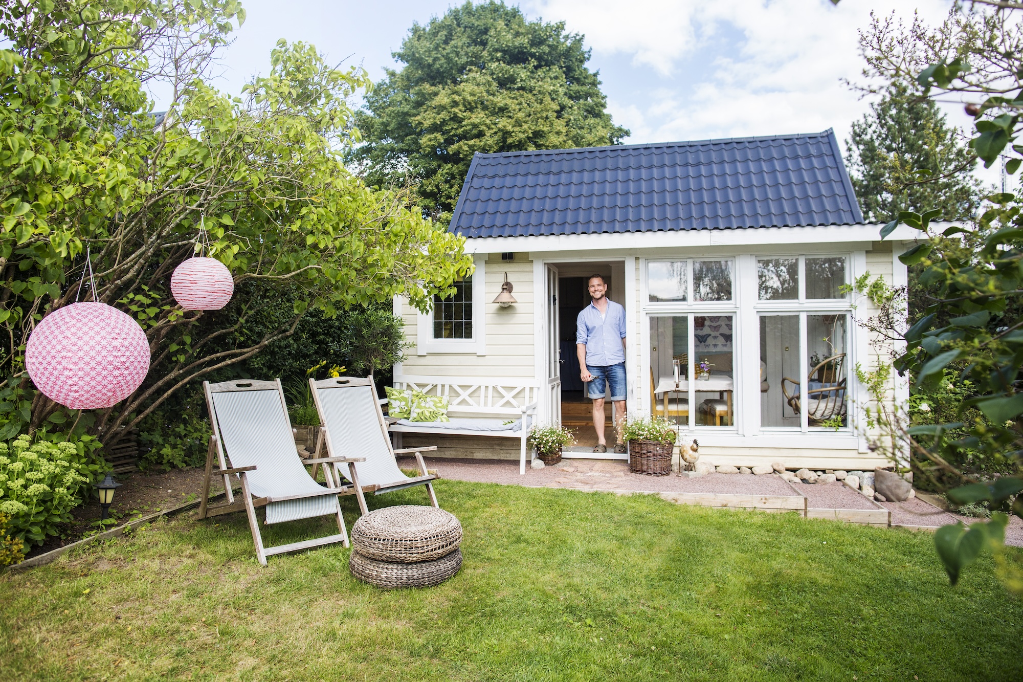 Man standing in front of his new summer home.