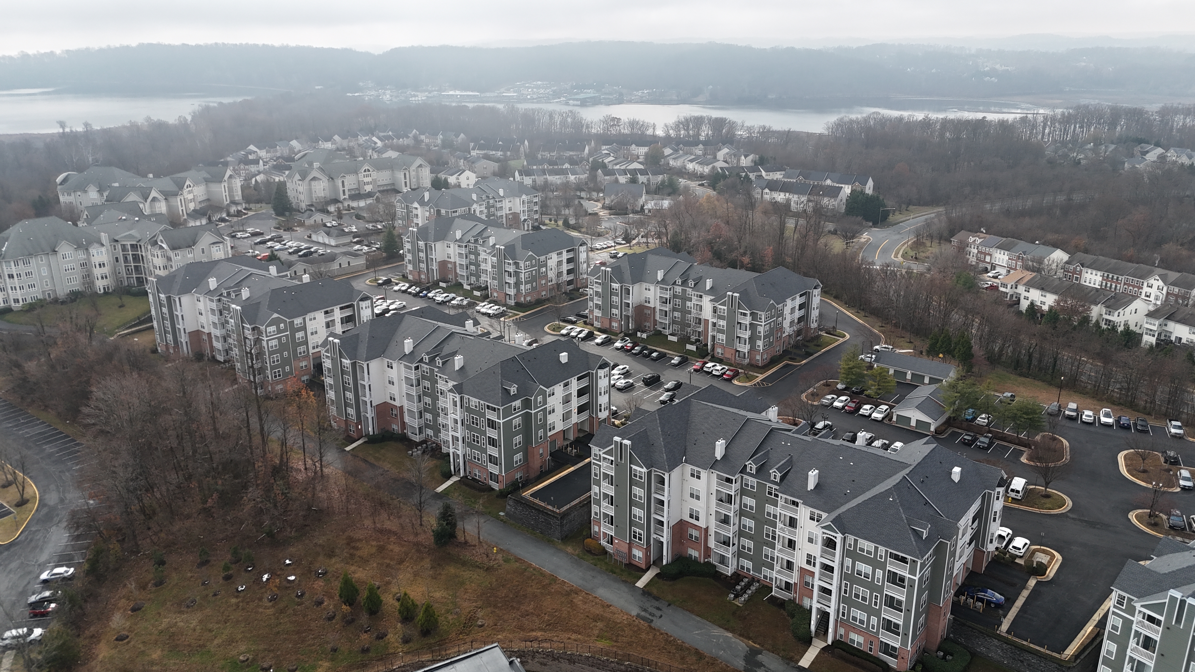 Apartments near Rippon VRE station in Woodbridge, Virginia, with trees and water in the background