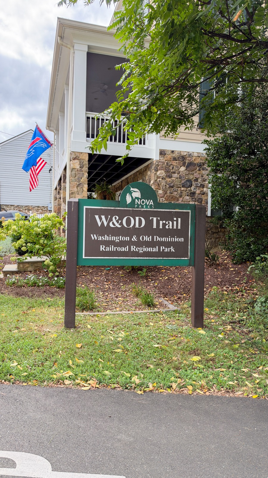 W&OD Trail sign beside a paved path in Leesburg, Virginia