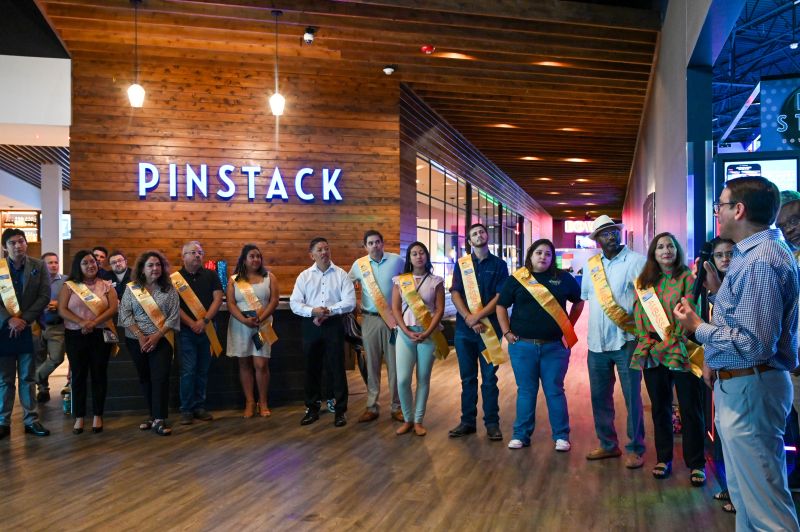A corporate or community event being held in the modern PINSTACK lobby, showcasing its appeal for private parties and group functions in Loudoun County.