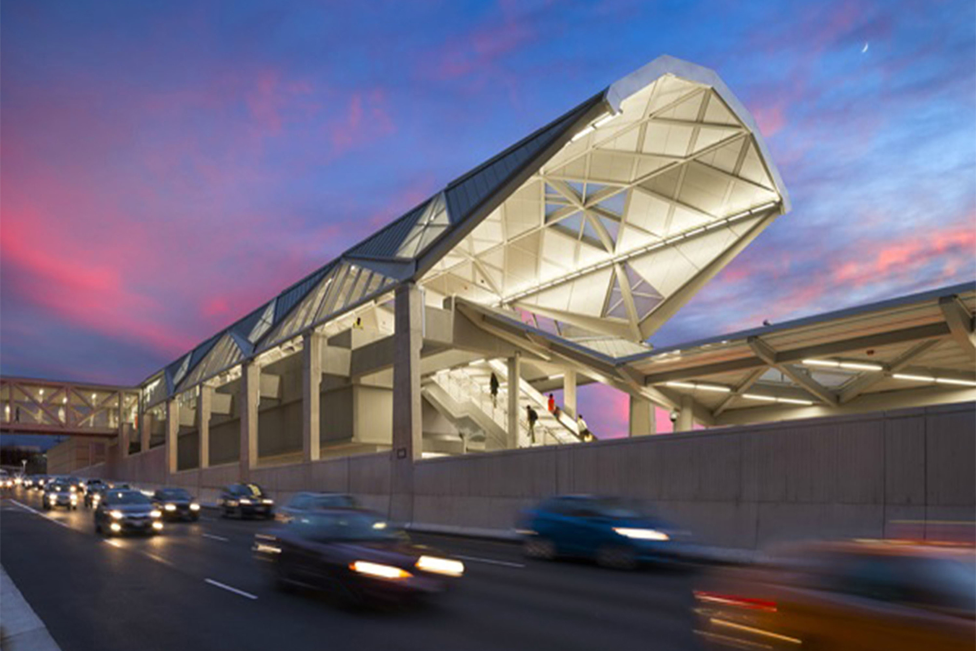 The modern architecture of the Dulles International Airport Metro Station at dusk, a key part of the Silver Line extension that enhances connectivity and boosts property values in Northern Virginia.