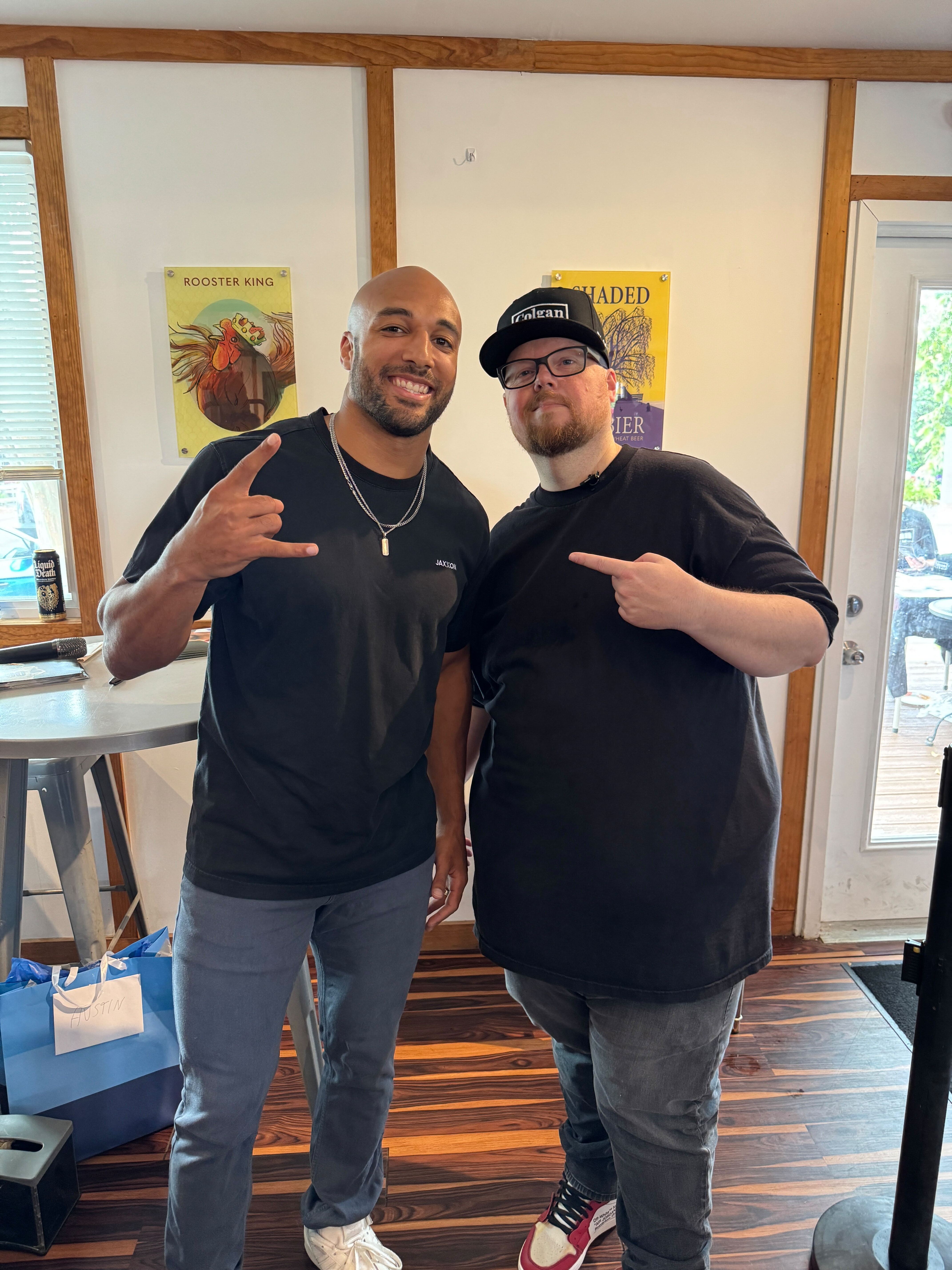 Washington Commanders running back Austin Ekeler and realtor Chris Colgan posing for a photo at the Colgan Team client appreciation event.