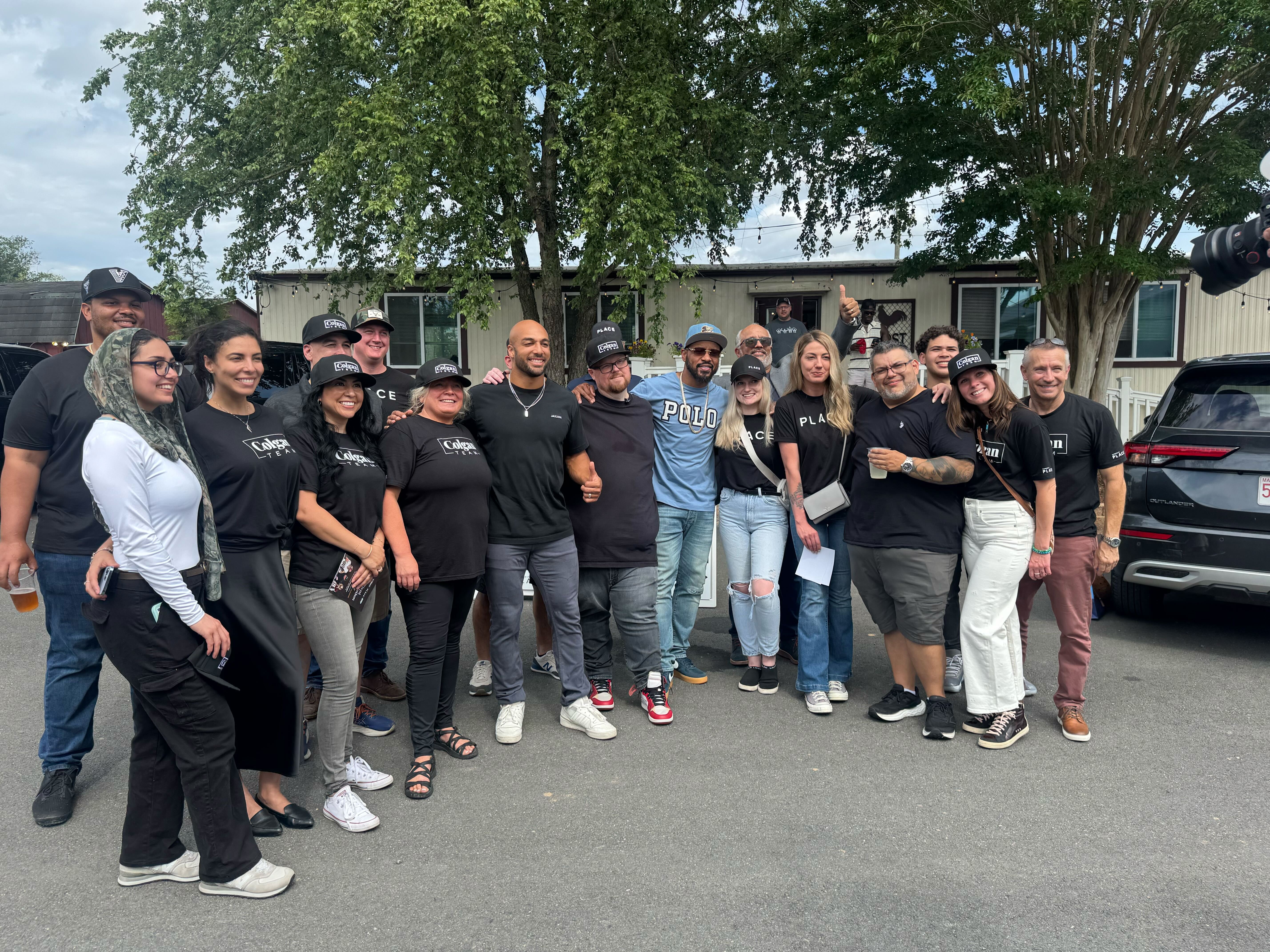 Group photo of the Colgan Team, Washington Commanders players, and guests at the client appreciation event at The Roost at Farm Brewery.