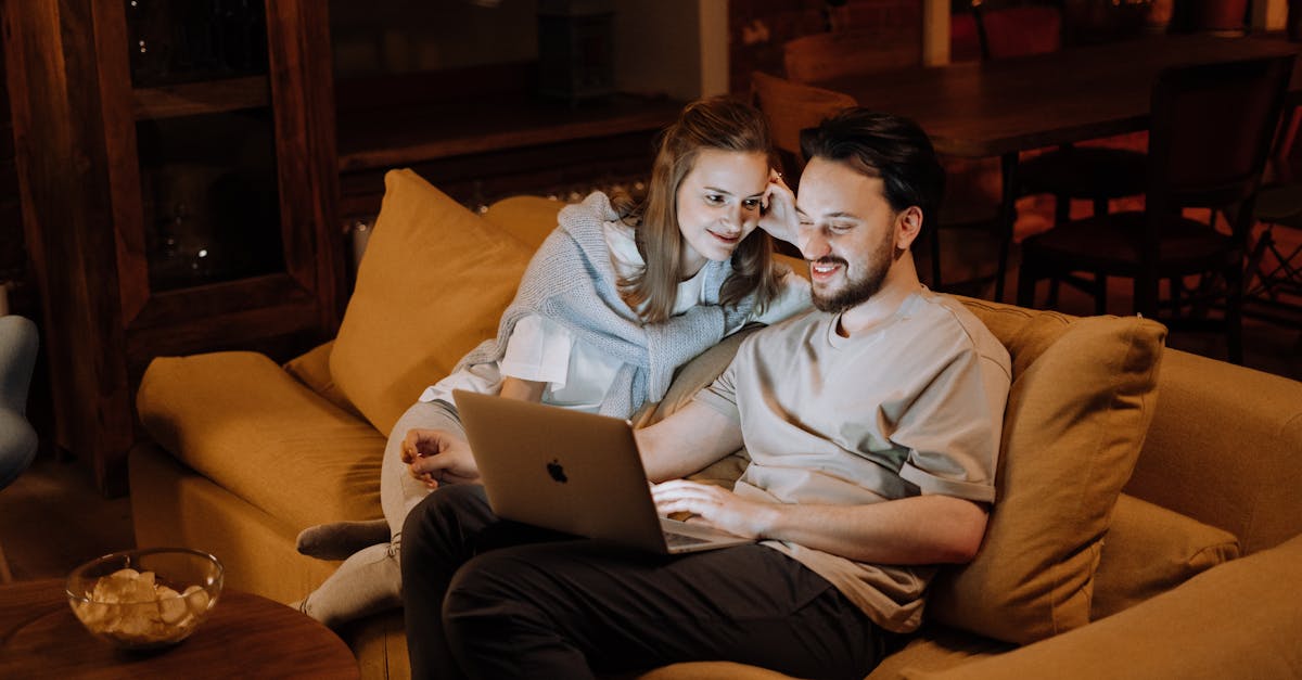 Couple reviewing home listings on a laptop in Northern Virginia.