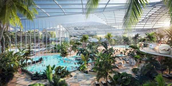 Wide artist rendering of the expansive interior of Therme DC, featuring multiple thermal pools, lush tropical botanical gardens, and lounge areas under a large glass roof.