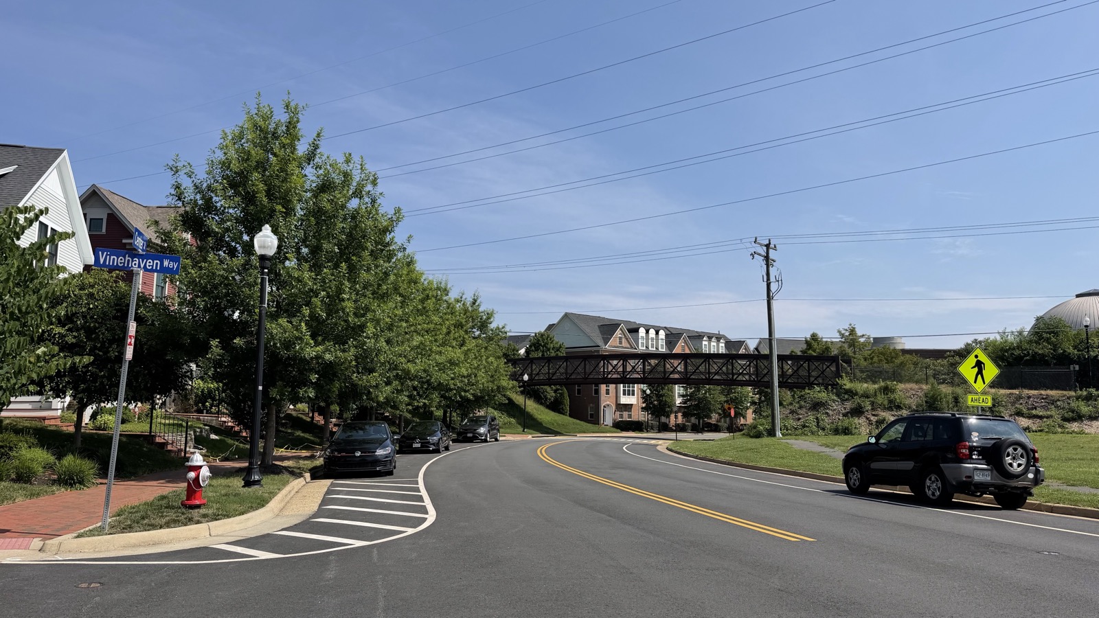 Herndon street near Vinehaven Way with homes and a pedestrian bridge