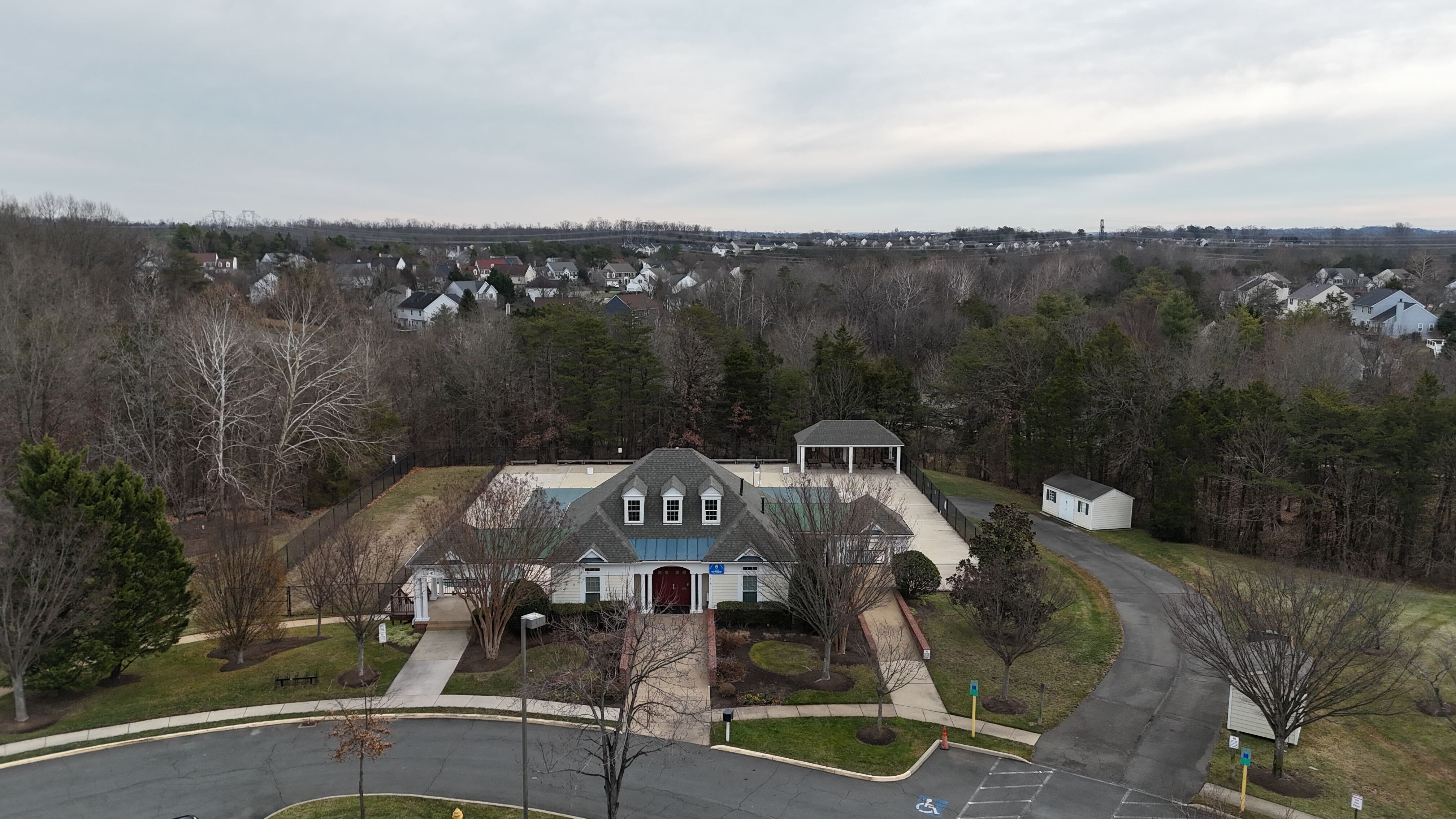 Kingsbrooke clubhouse and pool area with surrounding homes in Bristow, Virginia