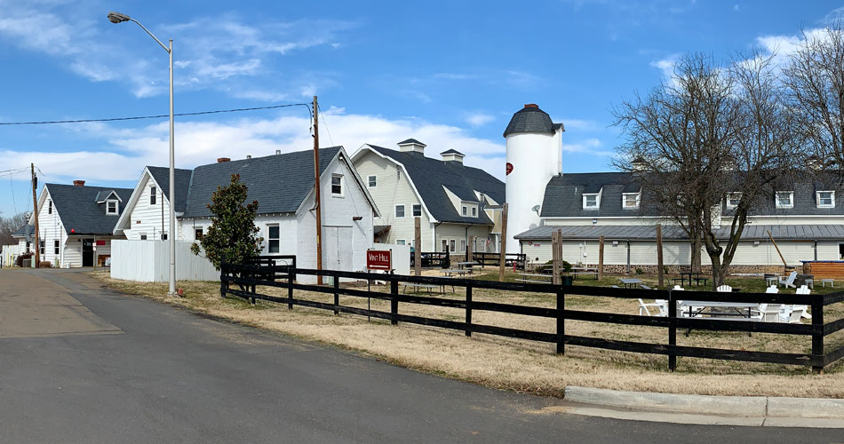 A panoramic view of the Vint Hill community in Virginia, showing the historic barns, silo, and modern real estate that make up this unique neighborhood.
