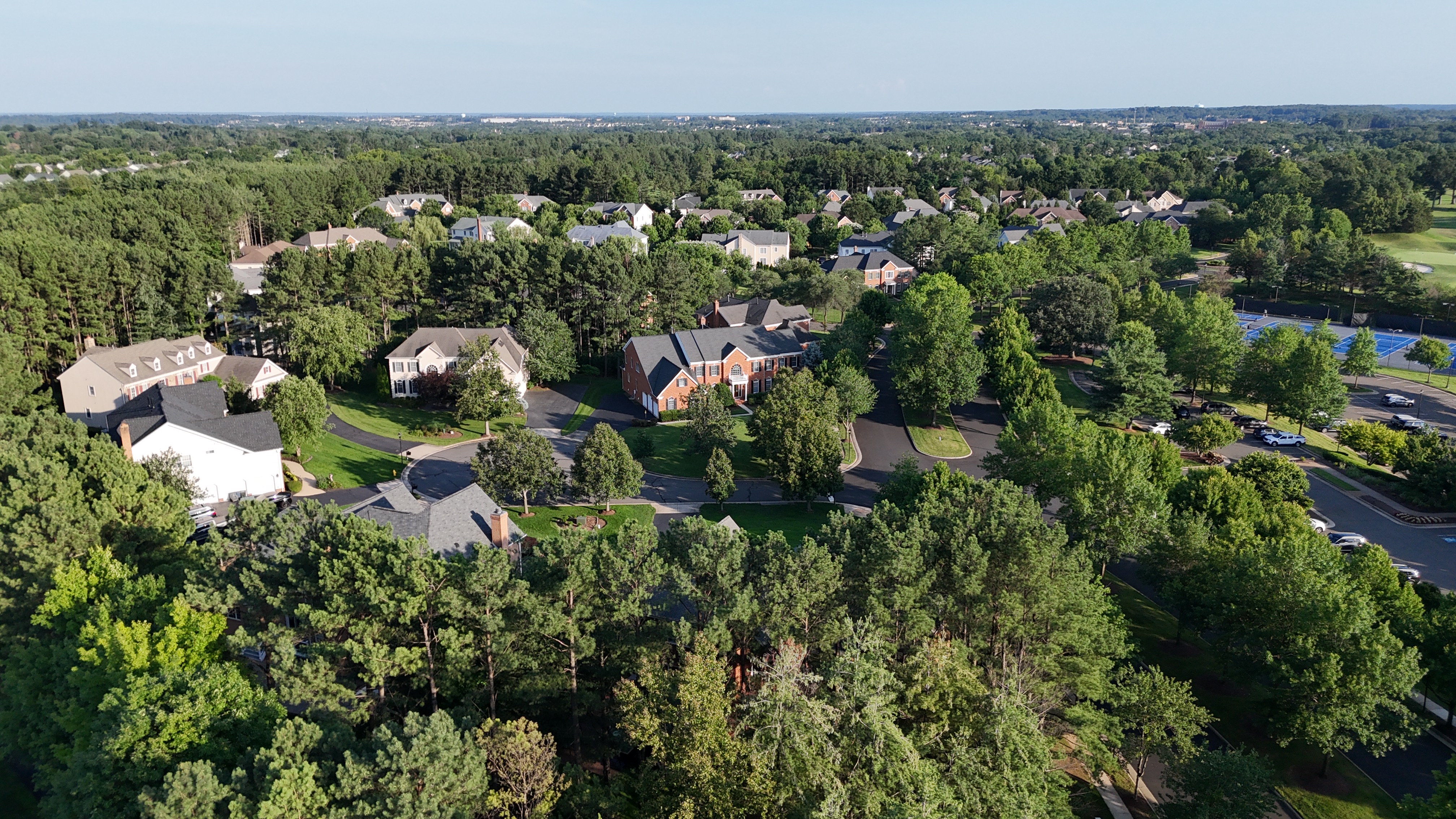 Aerial view of homes and tree-lined streets in Dominion Valley near Haymarket, Virginia